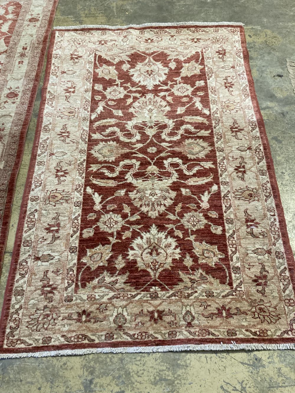 A near pair of Ziegler style red ground rugs, larger 255 x 125cm